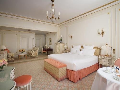 a bedroom with a large bed and a living room at The Ritz London in London