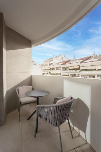 a balcony with a table and chairs and a window at Hotel Lima - Adults Recommended in Marbella