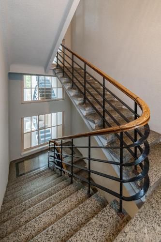 a spiral staircase in a building with a window at Freedom avenue apartment by Polo Apartments in Kaunas