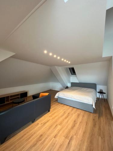 a bedroom with a bed and a wooden floor at T&T Apartments in Mönchmeierhof