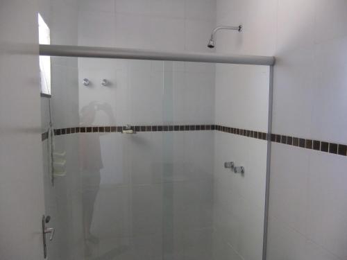 a shower with a glass door in a bathroom at Flex Hotel in Três Lagoas