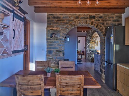 a kitchen and dining room with a table and chairs at VILLA STELLA, LEFKES PAROS in Lefkes