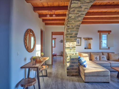 a living room with a couch and a table at VILLA STELLA, LEFKES PAROS in Lefkes