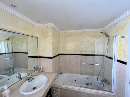 a bathroom with a sink and a tub and a shower at Quiet & Spacious Apt @ Golf Course w/ Roof Terrace in San Roque