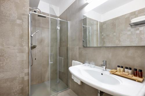 a bathroom with a sink and a shower at Hotel Gallia & Resort in Lido di Jesolo