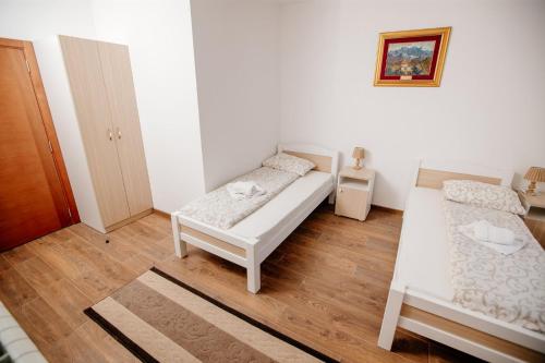 a small bedroom with two beds and a wooden floor at Piva lake in Plužine