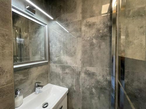 a bathroom with a sink and a mirror at Apartament u Beti in Opole