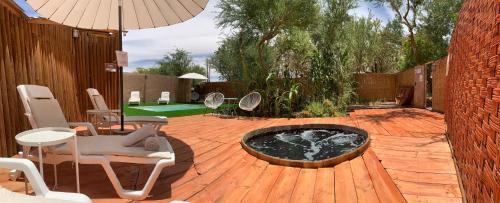 a patio with a fire pit on a wooden deck at Sami Atacama in San Pedro de Atacama