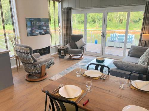 a living room with a wooden table and chairs at The Floating Home at Upton in Upton upon Severn