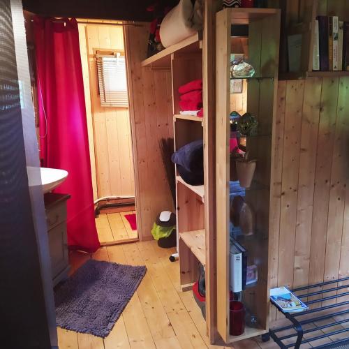 a room with a closet with wooden walls at CABANE CERISE DANS L'ARBRE Etapeboisee in Fumay