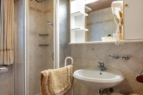 a bathroom with a sink and a shower at Cesa Soramurat Appartamento 9 in Canazei