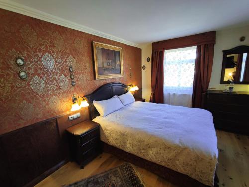 a bedroom with a large bed and a mirror at Hotel Adler in Sankt Georgen im Schwarzwald