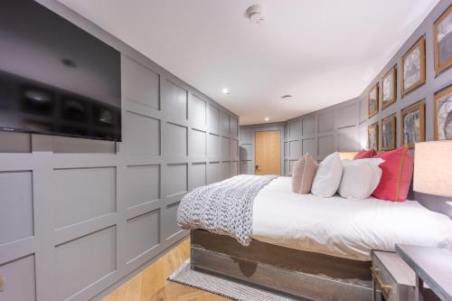 a bedroom with a large bed and a wall at No1 Apartments Edinburgh - New Town in Edinburgh