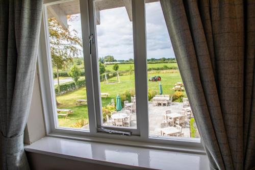 an open window with a view of a yard at Haighton Manor - Brunning and Price in Grimsargh