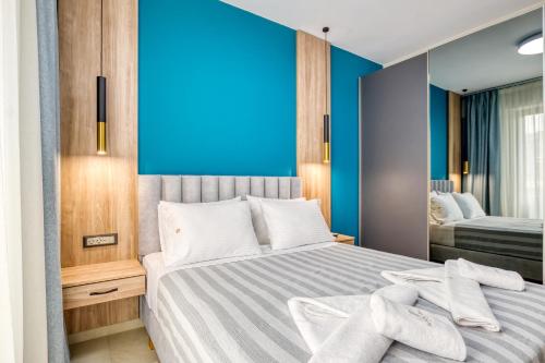 a bedroom with a bed with towels on it at Sapphire Horizon Suites in Kissamos