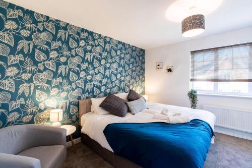 a bedroom with a large bed with a blue blanket at Contractor*Leisure*King Bed*Free Parking in Hull