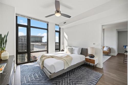 a bedroom with a bed and a large window at Placemakr Marymount Ballston in Arlington