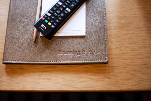 a remote control sitting on top of a table at Haighton Manor - Brunning and Price in Grimsargh