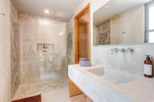 a bathroom with a sink and a shower at Chic Suites in the Heart of Tulum by Stella Rentals in Tulum