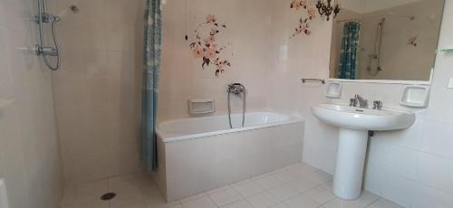 a bathroom with a tub and a sink and a shower at Casolare L'Antico Olivo in Chiesina Uzzanese