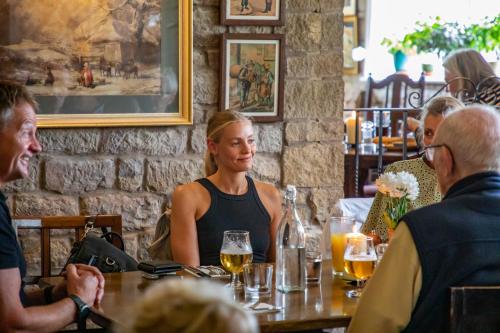 a group of people sitting at a table in a restaurant at Haighton Manor - Brunning and Price in Grimsargh