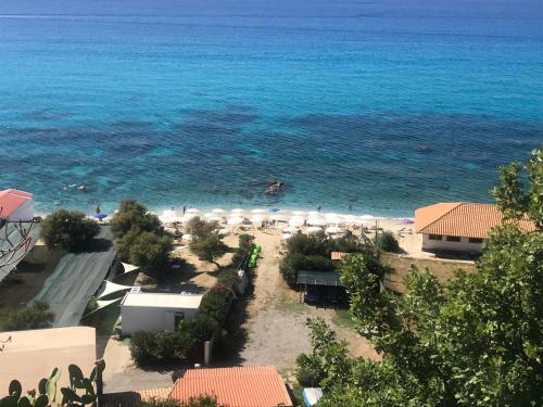 a view of a beach with umbrellas and the ocean at Residenza Gherly in Capo Vaticano