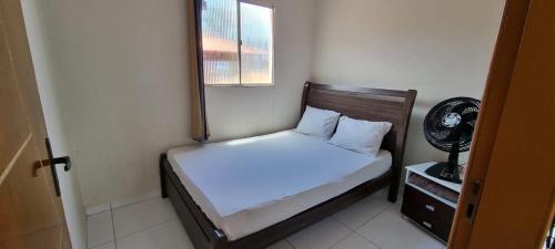 a small bedroom with a bed and a window at APT. CAMINHO DE MOISÉS in Maragogi