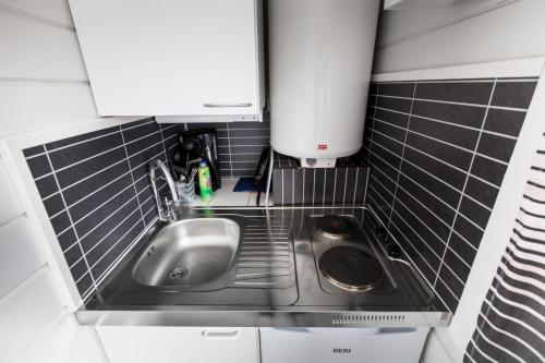 a kitchen with a sink and a counter top at Crow Creek Cabins in Inari