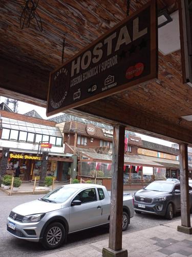 a sign for a hospital on a street with cars at Hostal Valentino in Villarrica