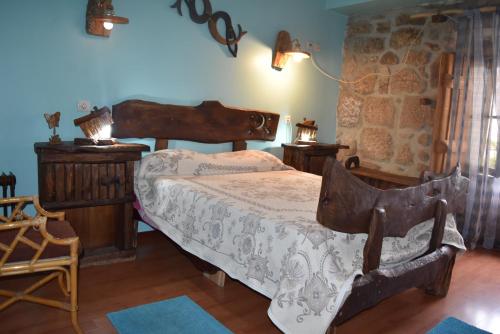 a bedroom with a bed and a stone wall at Casa na Serra da Estrela in Melo