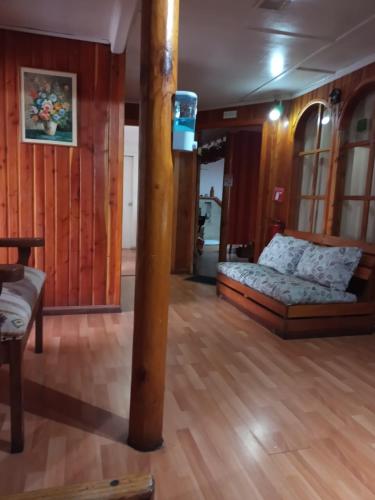 a room with a bed and a pole in it at Hostal Valentino in Villarrica