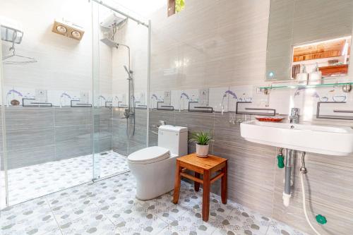 a bathroom with a toilet and a sink and a shower at Tam Coc mountain bungalow in Ninh Binh