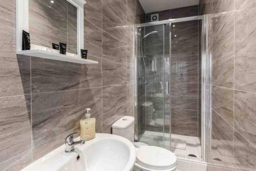 y baño con ducha, lavabo y aseo. en Modern Family Home With Parking-Pem en Liverpool