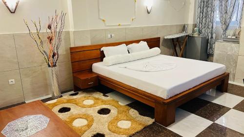 a bedroom with a large bed with a rug at RESIDENCE AMAR in Douala
