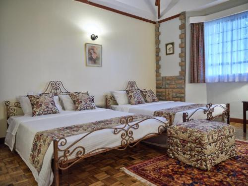 Ένα ή περισσότερα κρεβάτια σε δωμάτιο στο The Drexel House Kenya