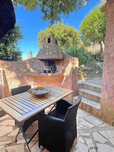 a table with a pizza oven on a patio at Résidence Storia di Blue in Porto-Vecchio