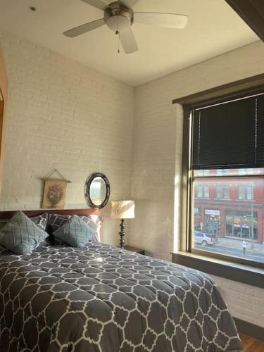 a bedroom with a large bed and a window at Charming 2 bedroom apartment near VCU in Richmond