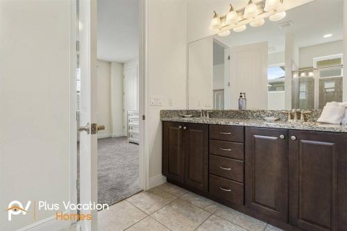 a bathroom with a sink and a large mirror at 331-Luxury Villa wPOOL & SPA By Disney in Orlando