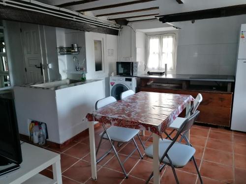 a kitchen with a table and chairs in it at Apartamento en Llanes in Llanes