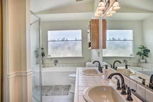 a bathroom with two sinks and a tub and a toilet at Bermuda Dunes Home with Private Pool and Hot Tub! in Bermuda Dunes