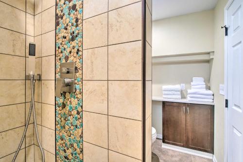 a bathroom with a shower with a tile wall at Cozy North Bend Getaway in Walkable Location! in North Bend