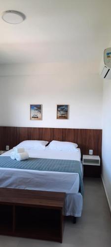 a bedroom with two beds and a wall with two pictures at Tree Bies Resort - Oficial in Subaúma