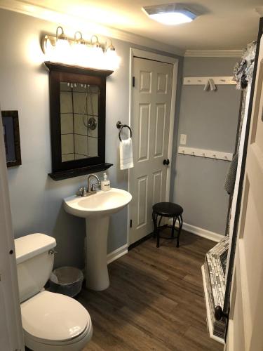 a bathroom with a white toilet and a sink at Belmont Inn in Shelbyville