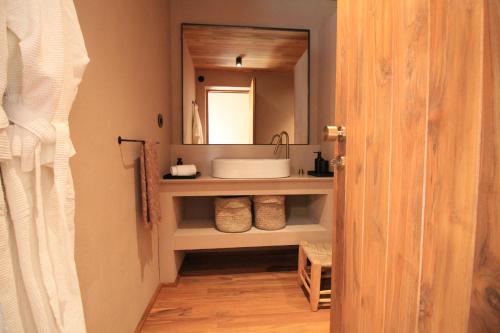 a bathroom with a sink and a mirror at Vinha by NHôme in Ponte de Lima