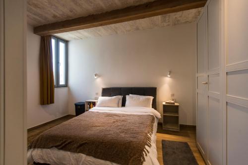 a bedroom with a large bed and a window at Valletta Collection - 101 Republic in Valletta