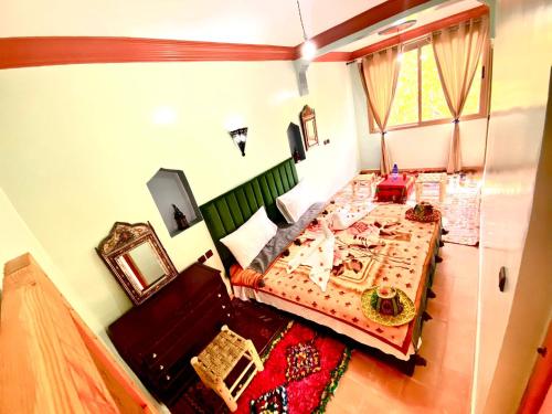 a small bedroom with a bed and a table at Atlas Views in Imlil