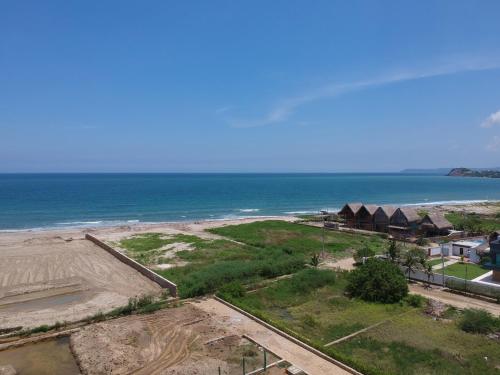 an aerial view of a beach with houses and the ocean at Ocean Club Resort Beach House in Juan de Acosta