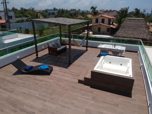 a patio with a tub on the roof of a house at Ocean Club Resort Beach House in Juan de Acosta