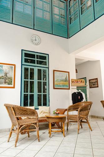 a living room with two chairs and a table at Hotel Deli River and Restaurant Omlandia in Medan