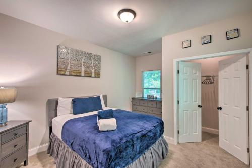 a bedroom with a bed with a blue blanket at Stylish College Park Home with Private Garden! in Atlanta